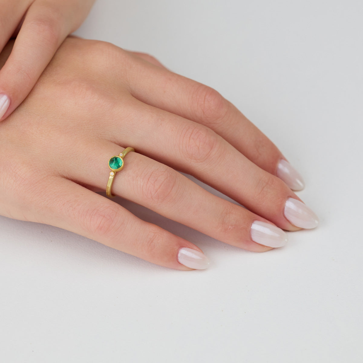 Delicate Emerald Ring with Two Diamonds